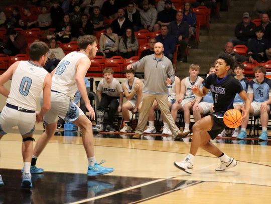 PM SOPHOMORE guard Langston Cook takes the ball toward inside the 3-point line as a pair of Patrick-Henry Glade Spring players wait for him on defense. Cook led the Fighting Blues with 21 points. (Lucretia VanBrocklin photo)