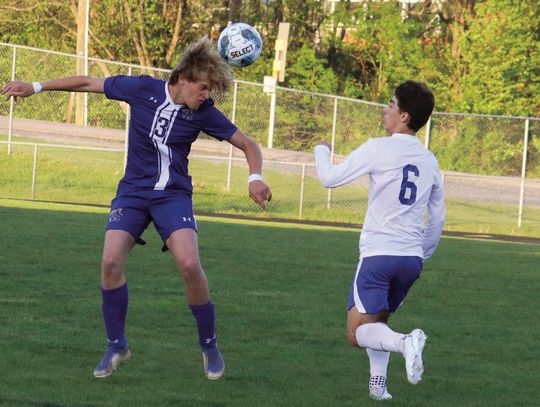 RC SENIOR forward John Huss Clement heads the ball as Spotswood’s Owen Albertson approaches