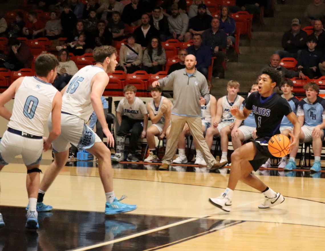 PM SOPHOMORE guard Langston Cook takes the ball toward inside the 3-point line as a pair of Patrick-Henry Glade Spring players wait for him on defense. Cook led the Fighting Blues with 21 points. (Lucretia VanBrocklin photo)