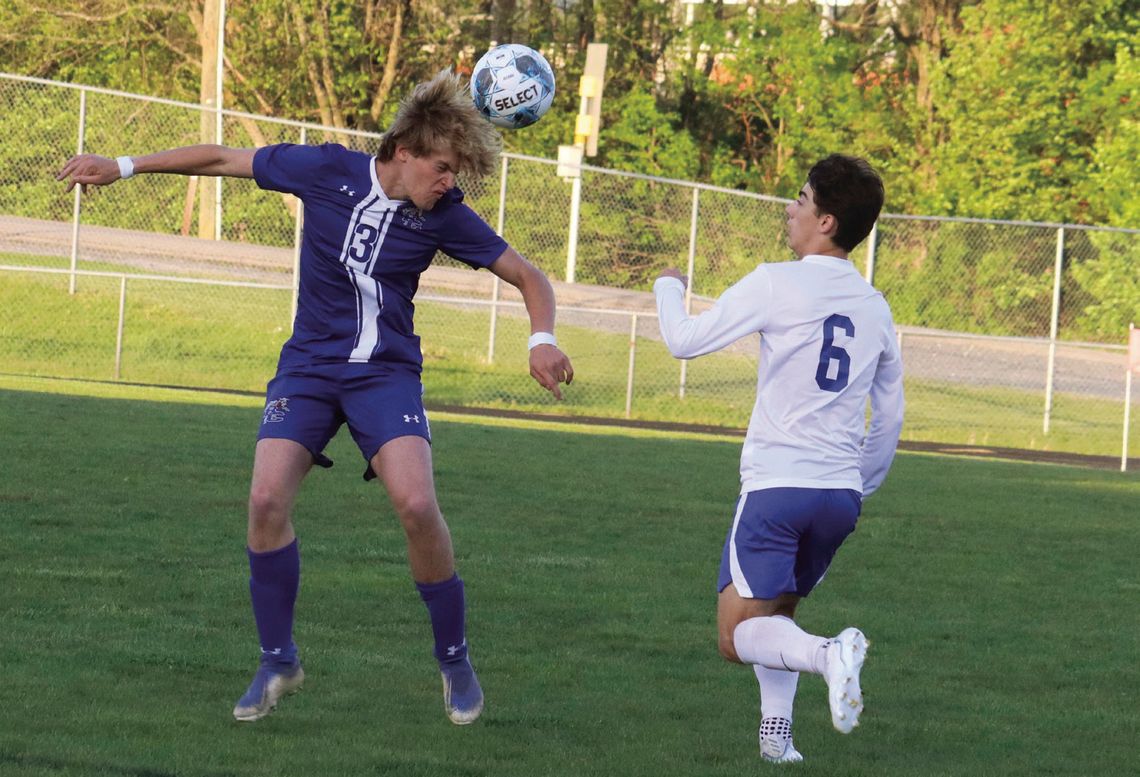 RC SENIOR forward John Huss Clement heads the ball as Spotswood’s Owen Albertson approaches